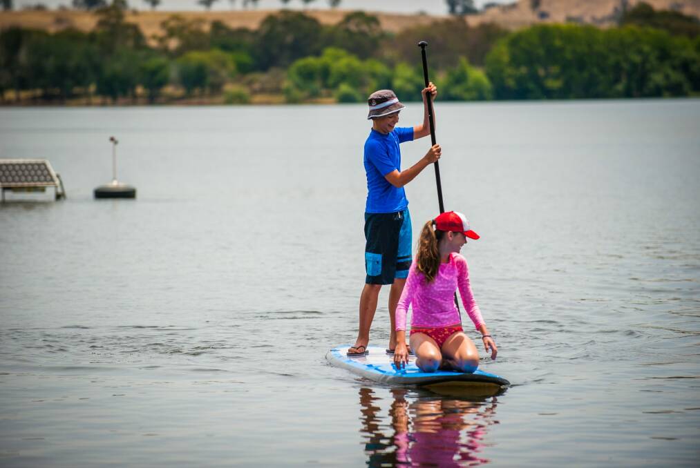 Harry Gibbs, of Red Hill, and cousin Coco Hyes enjoy the sunshine on New Year's Day at Yarralumla Bay but there is a change on the way. Photo: Elesa Kurtz