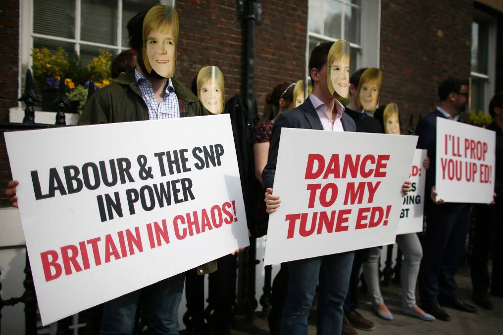 Conservative Party activists wearing Nicola Sturgeon masks protest ahead of a speech by Labour leader Ed Miliband. Photo: Getty Images
