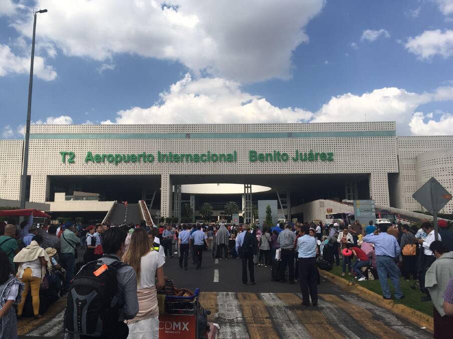 Travellers evacuate Mexico city airport following the earthquake. Photo: Jonathan Dampney