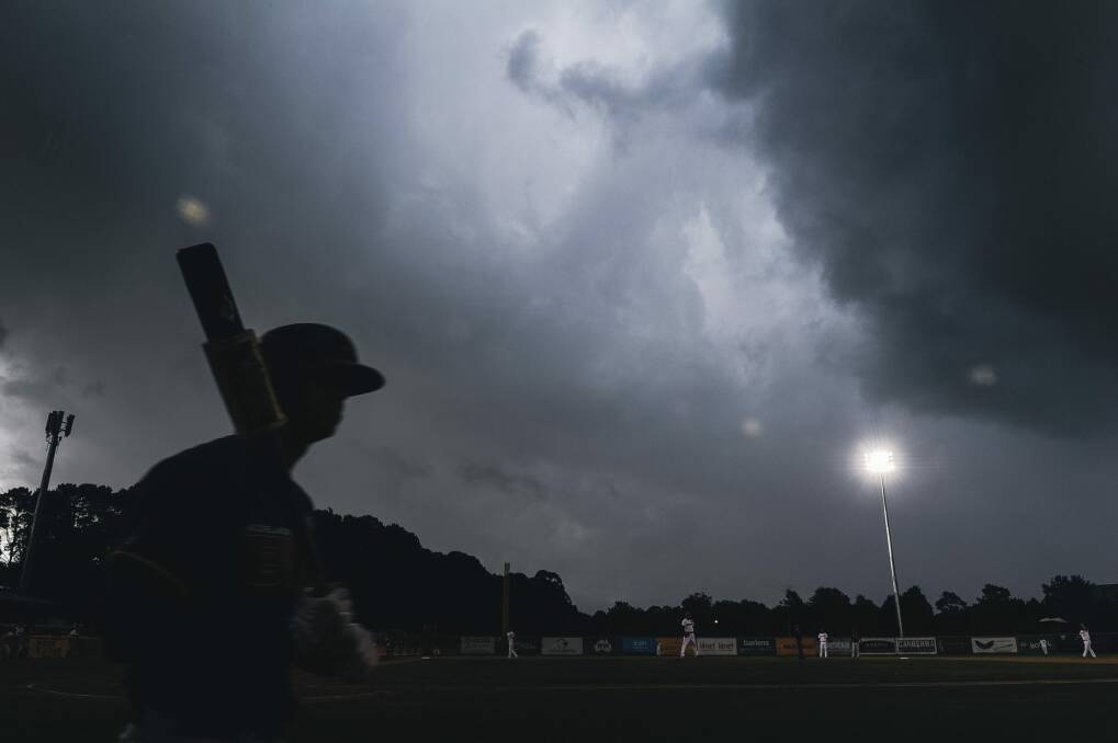 Hail arrives with a storm over Narrabundah during a baseball game.

 Photo: Rohan Thomson