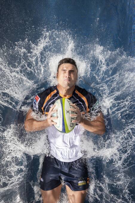 Tom Banks at the moment of impact for the Super Rugby guide photo shoot. Photo: Sitthixay Ditthavong