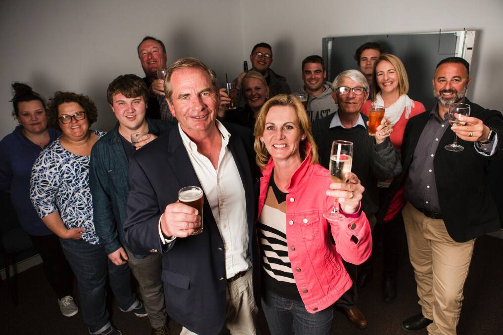 Former Queanbeyan Mayor Tim Overall celebrates on election night with wife Nichole and his team. Photo: Jamila Toderas