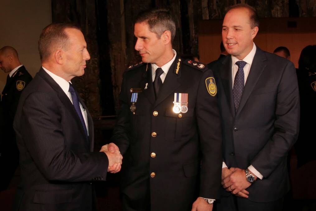 Immigration Minister Peter Dutton, with Prime Minister Tony Abbott at the swearing in ceremony of inaugural Border Force Commissioner Roman Quaedvlieg in July. Photo: Andrew Meares