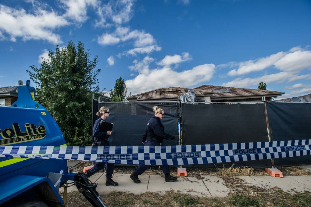 Forensic investigators at the scene of the house fire and three deaths in Bonner. Photo: Karleen Minney