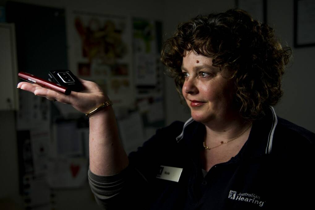 Clinical assistant at Australian Hearing Nicola Field has a number of devices to help her hear. Photo: Jay Cronan