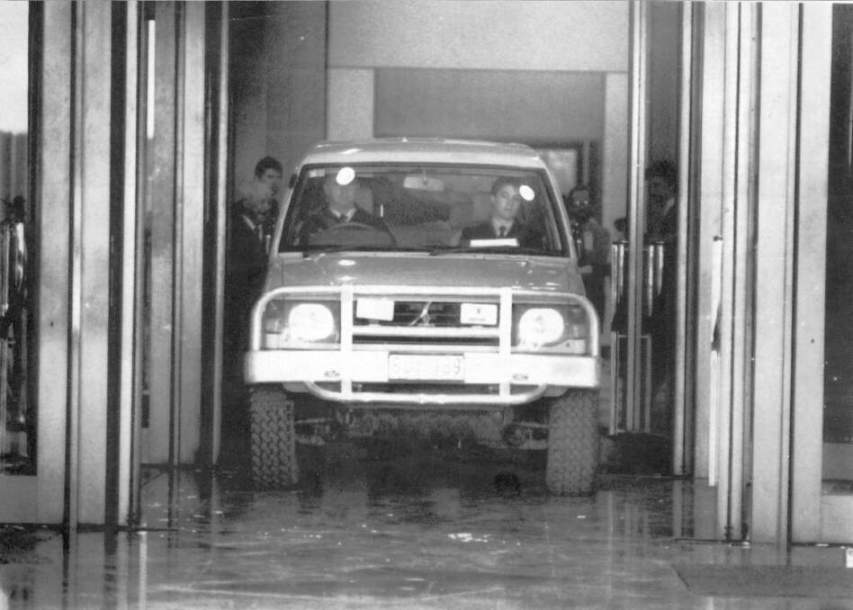 A police officer drives the Pajero out of the Parliament House foyer in 1992 after it was crashed into the building. Photo: Supplied