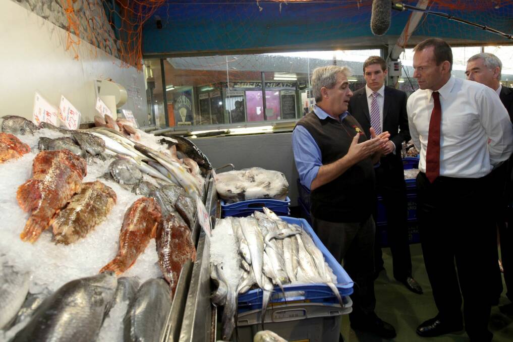 Then-opposition leader Tony Abbott speaks with John Fragopoulos during a visit to the Belconnen Fresh Food Markets in 2011.
 Photo: Alex Ellinghausen / Fairfax