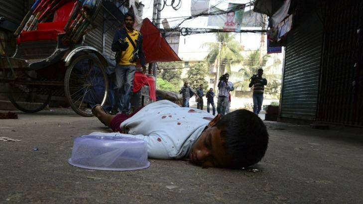 Victim: A boy lies on the ground after being injured by rubber bullets fired by police during clashes between Jamaat-e-Islami activists and police in Dhaka. Photo: Reuters