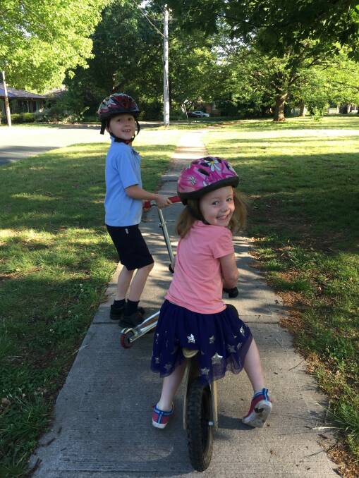 Aidan and Maeve Moloney enjoying the daily routine of getting to school on foot or two wheels. Photo: Supplied