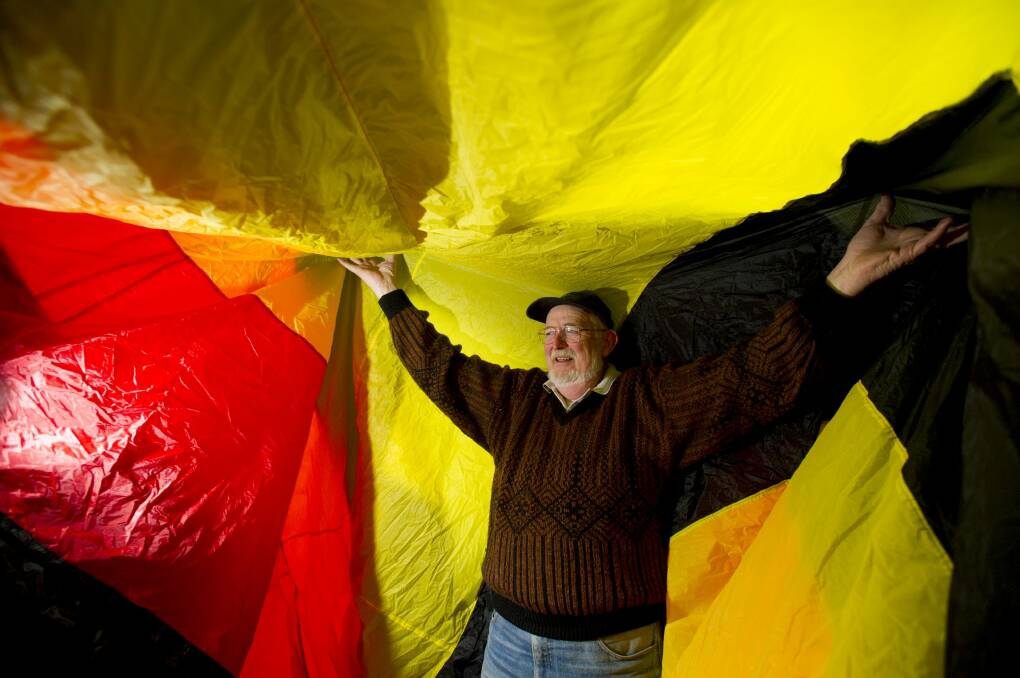 Ian Burrell stands inside the caterpillar kite that will be flying over Googong. Photo: Jay Cronan