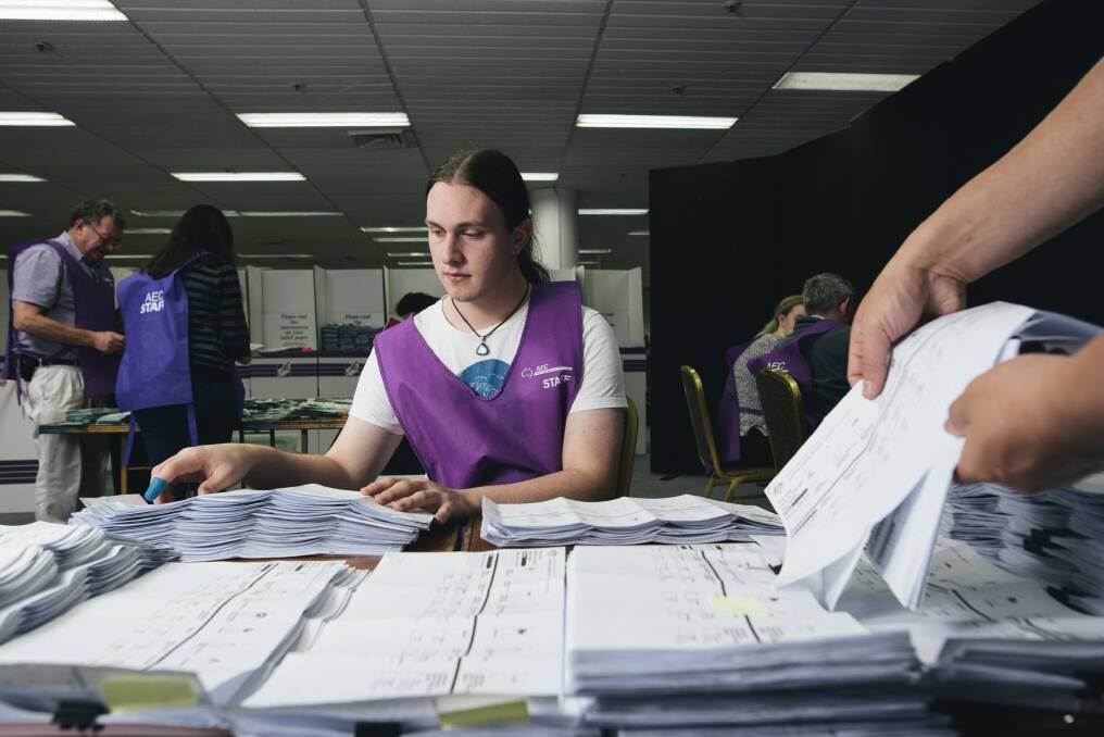 Lindsay Usher counting postal votes at the Australian Electoral Commission counting room in Civic.  Photo: Rohan Thomson
