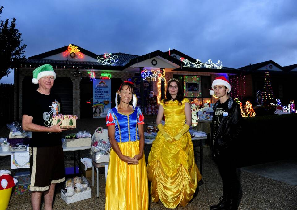 The Anthoney family of Gungahlin. From left, Stephen, Yvonne, Nalani, 21, and Jarrett, 20, with their Christmas lights display. Photo: Melissa Adams