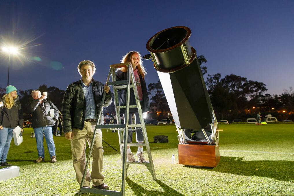 Anthony and Holly Todd of Belconnen drew a constant stream of admirers during the stargazing Guinness World Record attempt with their homemade Dobsonian telescope. Photo: Sitthixay Ditthavong
