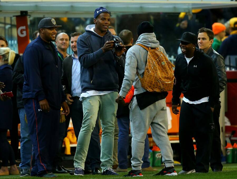 Impressed: NFL star Cam Newton at the MCG on Friday night. Photo: Justine Walker/AFL Media