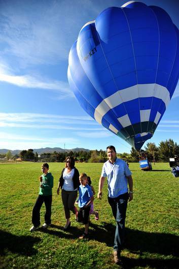 ACT Liberal leader Zed Seselja and the "Vote Liberal" hot air balloon which was requested to be moved the mandatory 100 metres from a polling booth. Mr Seselja's family Ros, Tommy, 10, William, 7, and Olivia, 5 accompany him to the polling booth. Photo: Karleen Minney