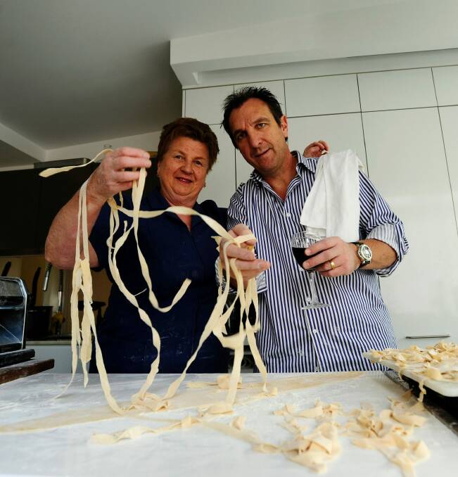 Happier times: Restauranteur Carlo Tosolini makes pasta with his mother Tina Tosolini. Photo: Stuart Walmsley