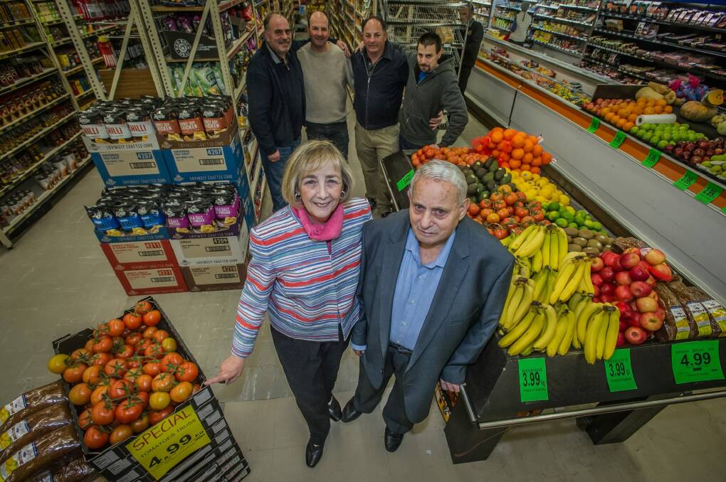Olympia and Chris  Maleganeas with four of their five sons (l-r) John, Michael, Steven and Con (Christopher was absent) at the Red Hill supermarket the family ran for 51 years. Photo: Karleen Minney