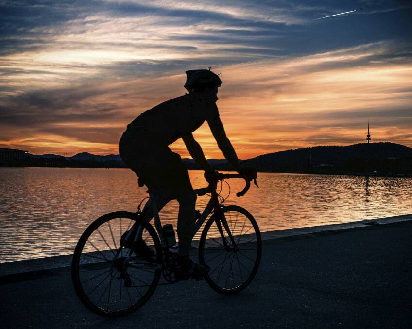 Canberra Times Our Lake – 50 years readers photo competition entry "Twilight Ride" Photo: Andrew Lance