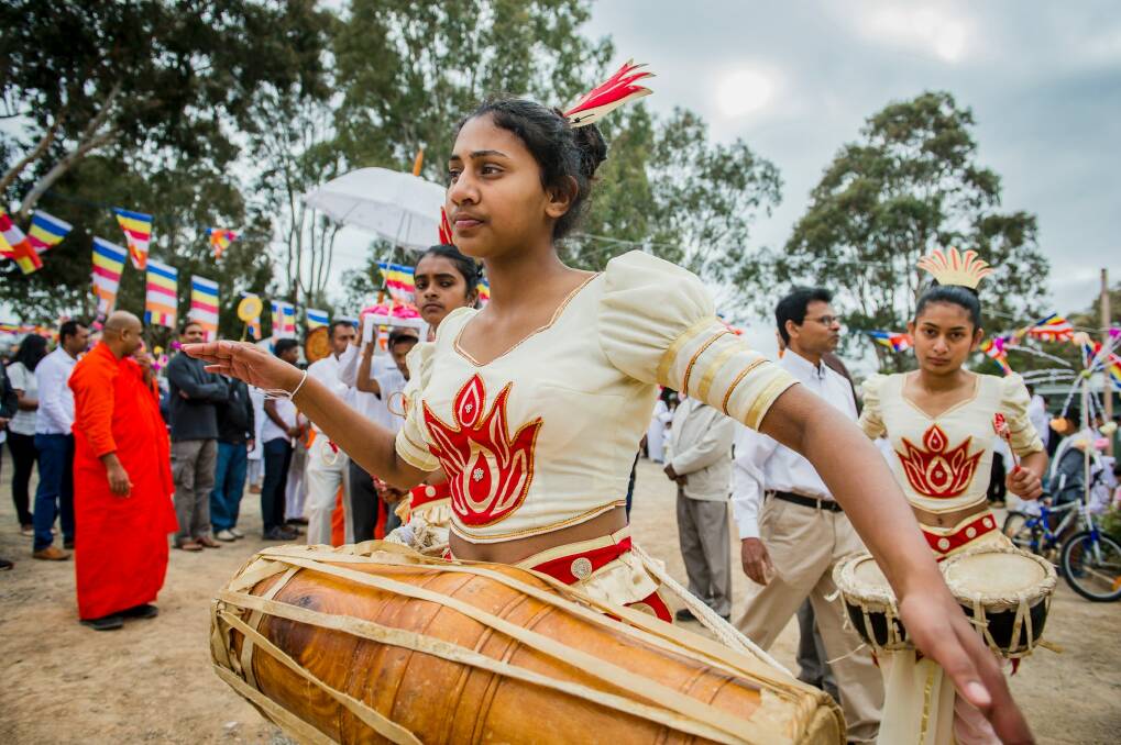 Devotees danced and beat drums as the street parade wound its way around Jenke Circuit to the Sri Lankan Buddhist Temple in Kambah. Photo: Sitthixay Ditthavong