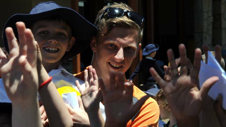 GWS Giants No.1 draft pick Lachie Whitfield entertains kids from Burgmann College. Photo: Graham Tidy