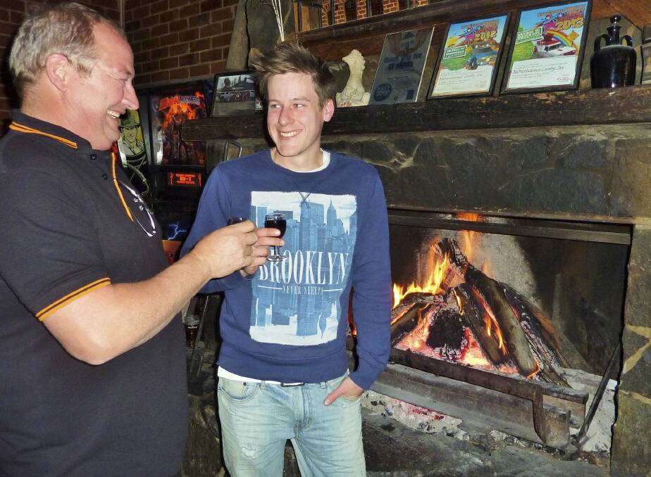 Your good health: Dave Laird, left,  and Andy McLean of the Murrumbateman Country Inn enjoy a port in front of the roaring open fire. Photo: Tim the Yowie Man