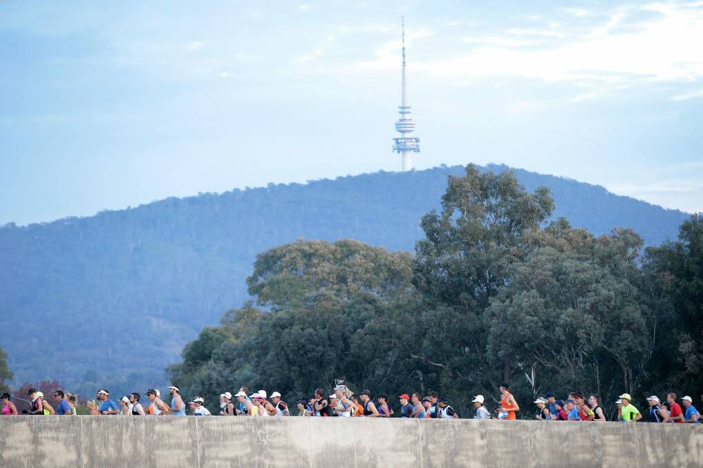 Runners approach Parliament House during the 2015 Canberra Times Running Festival marathon.  Photo: Jeffrey Chan