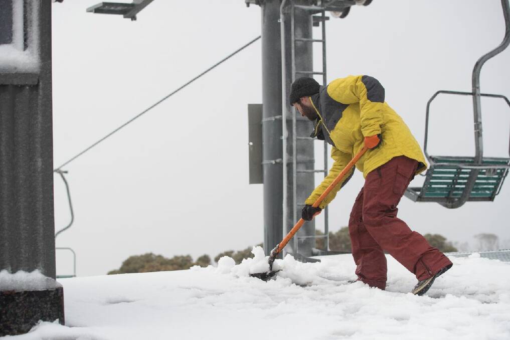 Snow is shovelled at Thredbo after a 5cm fall at the weekend. Photo: Thredbo