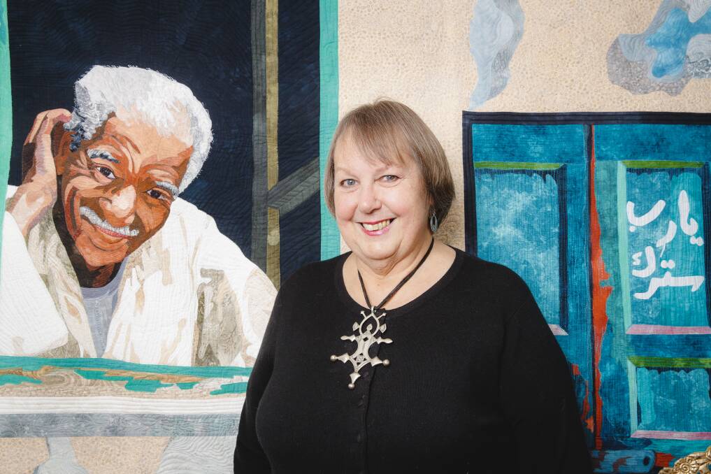 Quilter Jennifer Bowker, who has been named an officer in the Order of Australia for her achievements in quilting. Mrs Bowker is pictured with her quilt depicting a friend. Photo: Sitthixay Ditthavong