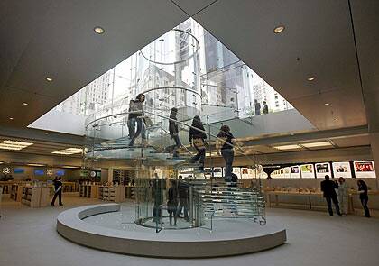 Heading to Canberra? Customers descend a glass staircase at the flagship Apple store on New York's Fifth Avenue. Photo: Reuters