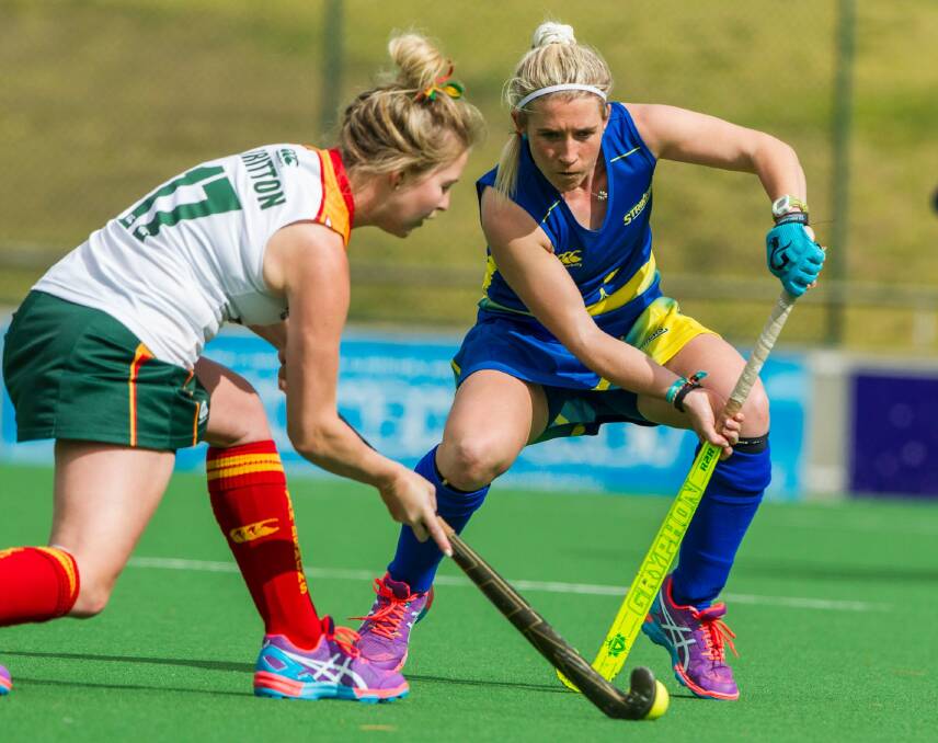 Naomi Evans, right, in action for Canberra against Tasmania. Photo: ClickinFocus