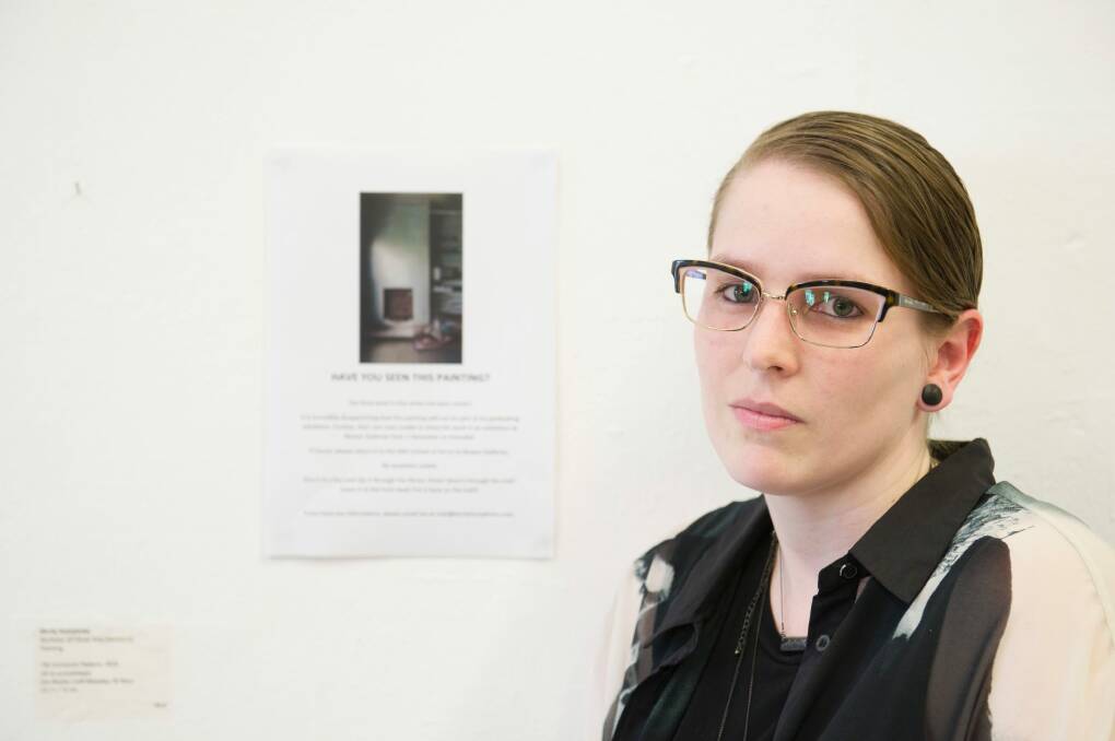 ANU Art Student Kirrily Humphries stands before a notice appealing from her stolen artwork to be returned.  Photo: Jay Cronan