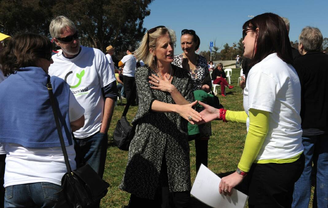 ACT chief minister Katy Gallagher is greeted by Brianna Heseltine, founder of the Mr Fluffy Owners and Residents' Action Group. Photo: Graham Tidy