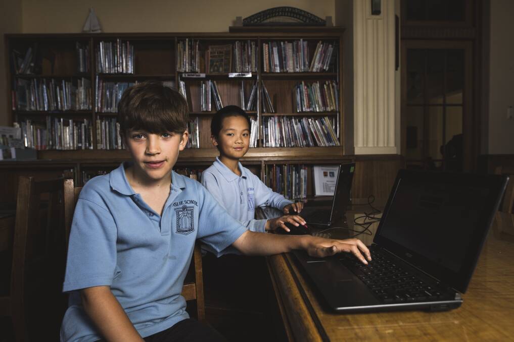 Ainslie School Year 5 students (front) Ned Bonyhady 9, and (behind) Max Ai, 10, practice their NAPLAN test online. Photo: Jamila Toderas