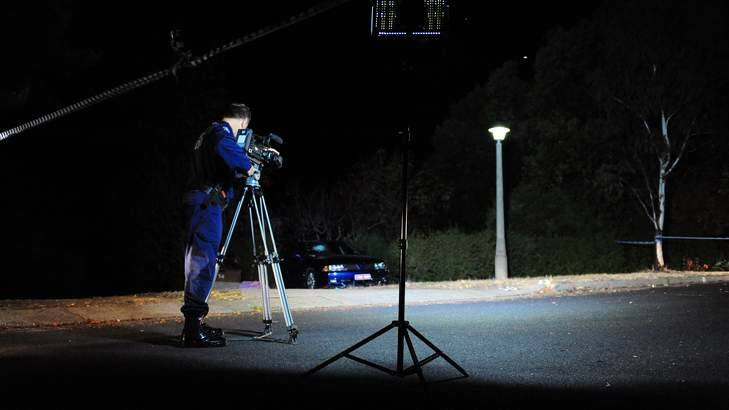 An ACT police officer takes video evidence at the scene. Photo: Karleen Minney