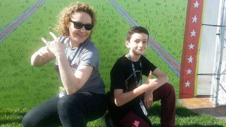 Triple j DJ Zan Rowe handed over to Canberra year six student Rhys Toms at Sunday's Groovin the Moo. Photo: Supplied