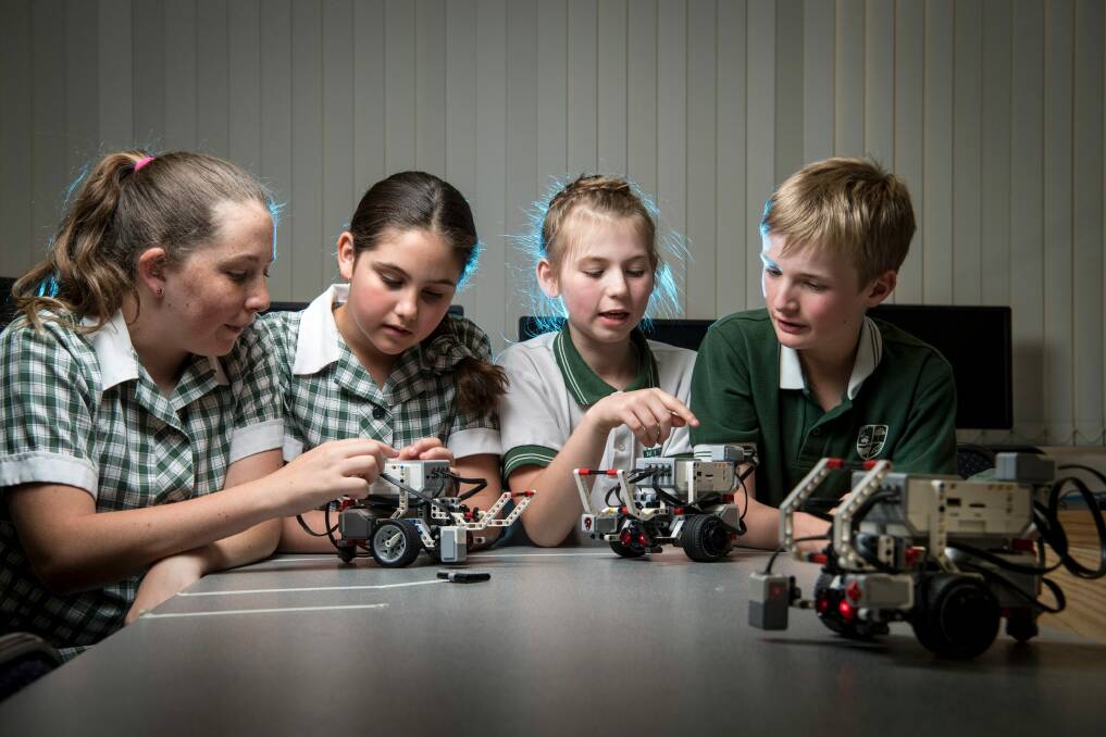 Mitcham Primary School students Megan, Hailey, Jordan and Aidan have been programming robots to boost their science and maths skills. Photo: Eddie Jim
