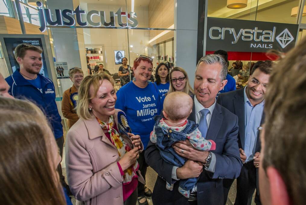 Leader of the opposition Jeremy Hanson holds Annabel, Alistair Coe's daughter, in the Gungahlin shopping centre. Photo: Karleen Minney