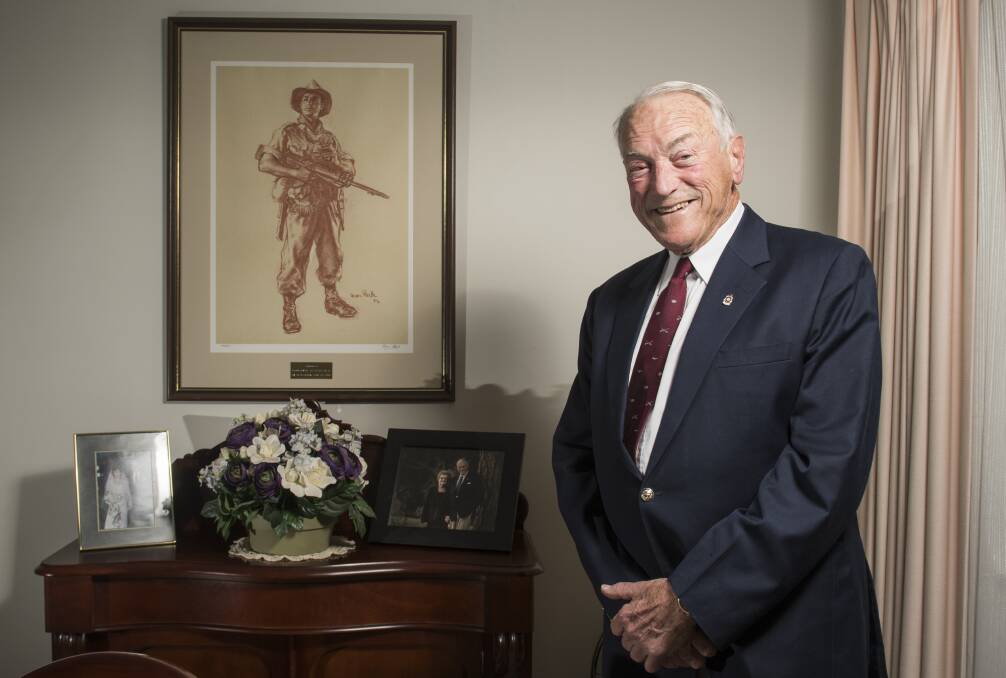 Major General Peter Phillips (Ret) was the commander of D Company, 3 RAR, during the battle of Coral Balmoral. He is pictured with an iconic image of a digger in New Guinea by Ivor Hele. Photo: Elese Kurtz