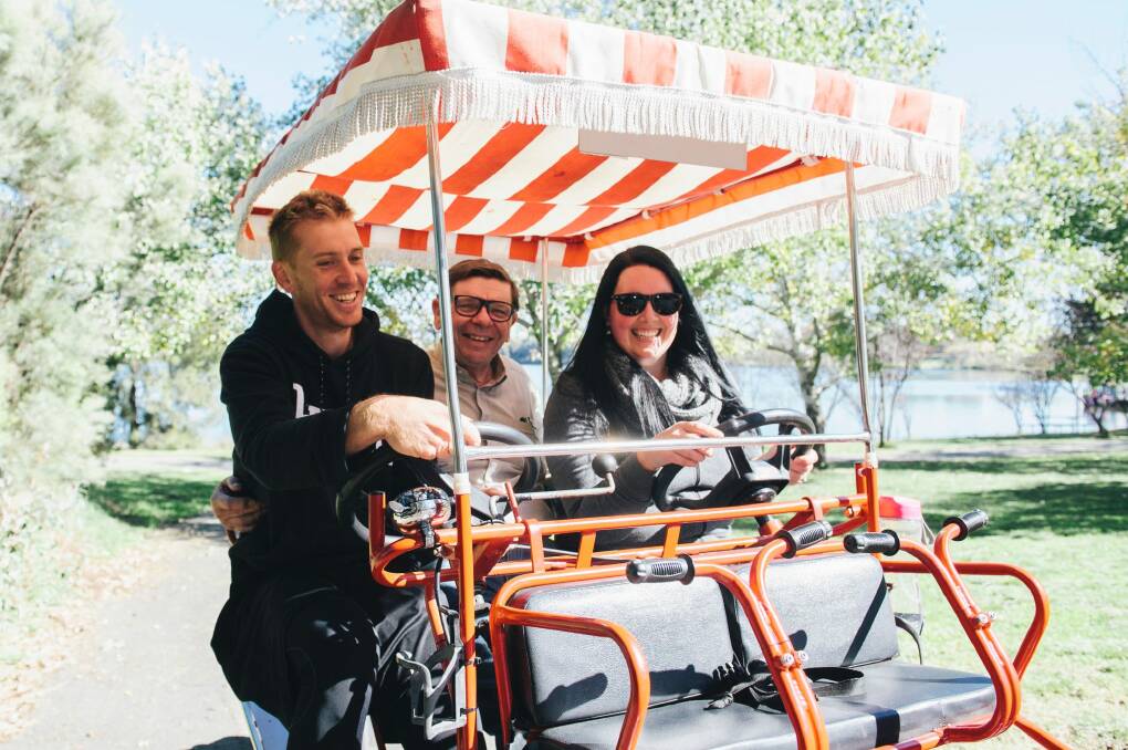 Bryan Guest of Harrison with his grandson Nathan Rowley and his wife Jessica of Adelaide enjoying the bike hire by the lake before it closes on Sunday. Photo: Rohan Thomson