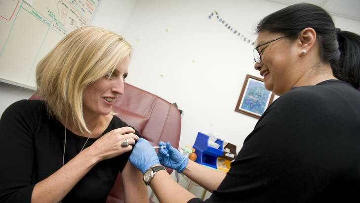 ACT Chief Minister and Minister for Health, Katy Gallagher, receives her flu vaccination from clinical nurse Joyce Ho-Chinn. Photo: Elesa Kurtz