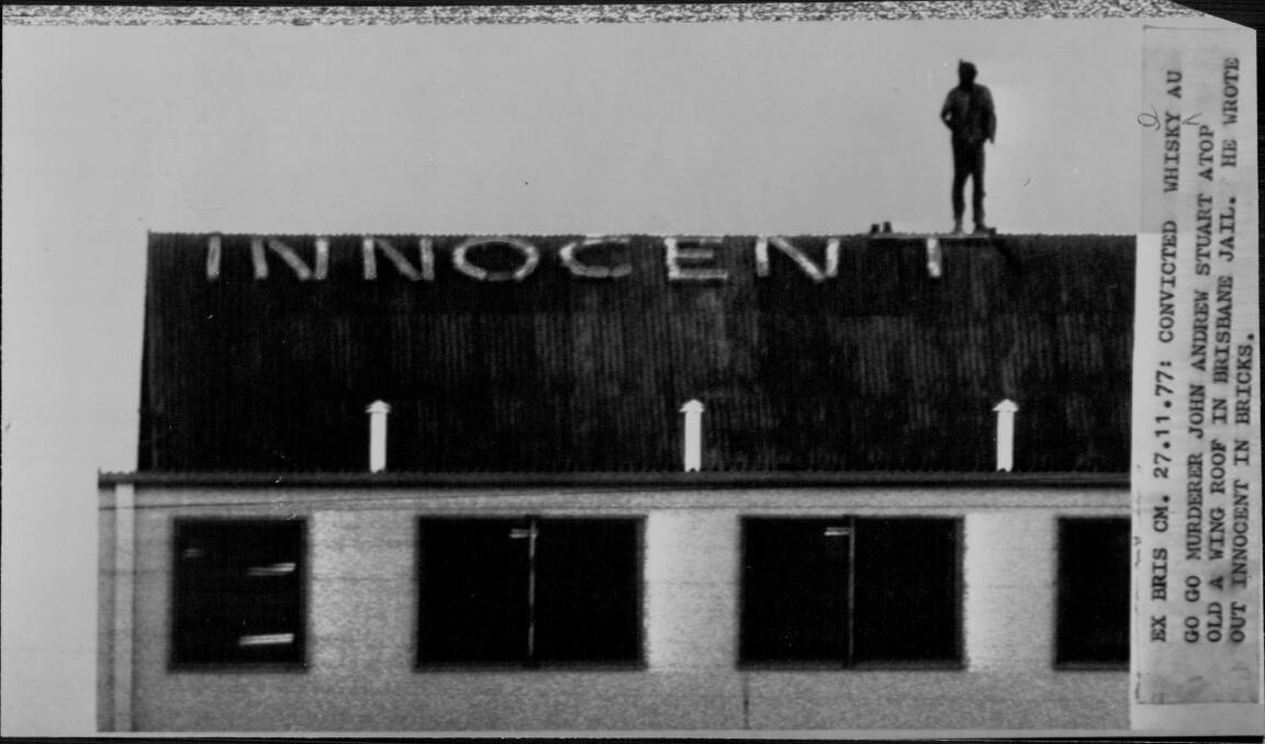Convicted Whiskey Au Go Go murderer John Andrew Stuart on top of a cell block at Boggo Road where he spelled out 'innocent'. Photo: Fairfax