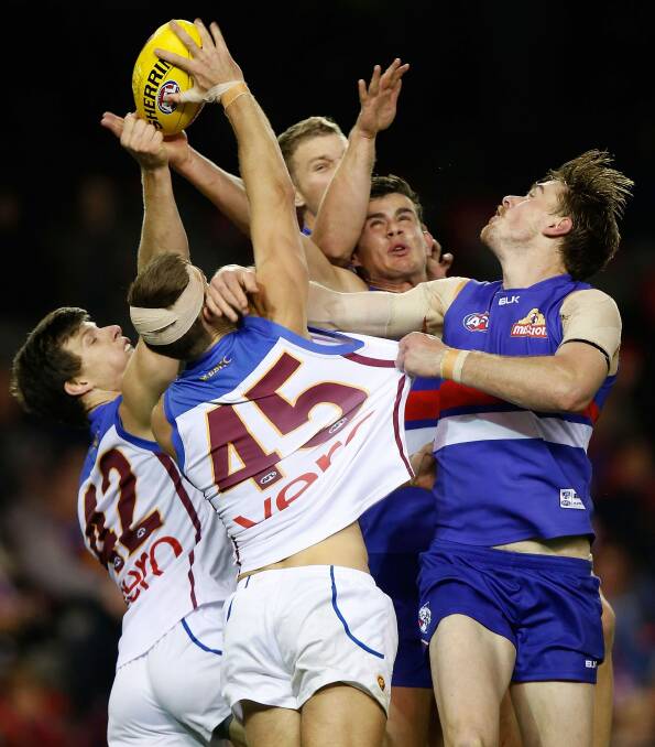 Justin Clarke and Jordon Bourke of the Lions compete for the ball with Tom Boyd and Jordan Roughead of the Bulldogs. Photo: Getty Images