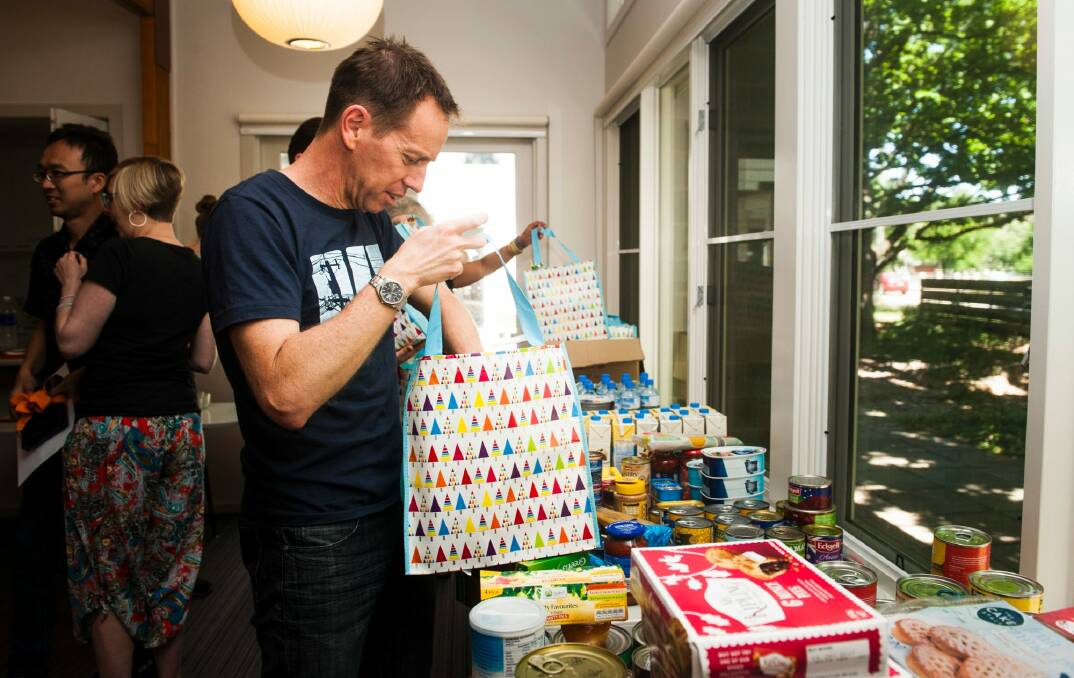 Corrections Minister Shane Rattenbury helped volunteers pack hampers for AMC detainees in the lead up to Christmas.  Photo: Elesa Kurtz