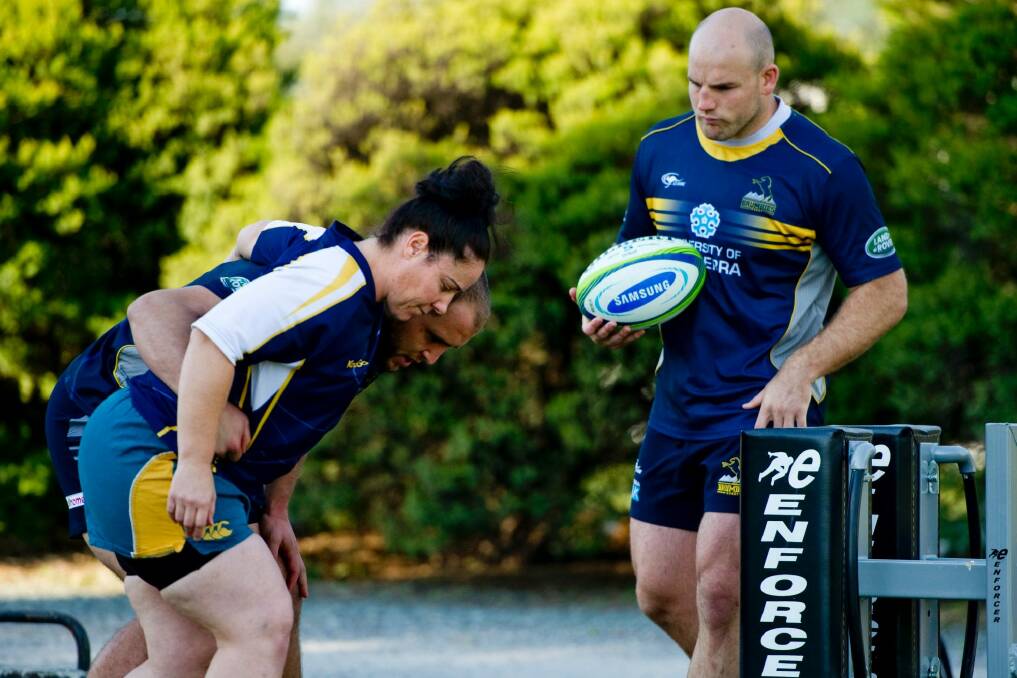 Wallaroos front rower Louise Burrows getting some pointers from Brumbies players Stephen Moore and Ben Alexander in 2014. Photo: Jay Cronan