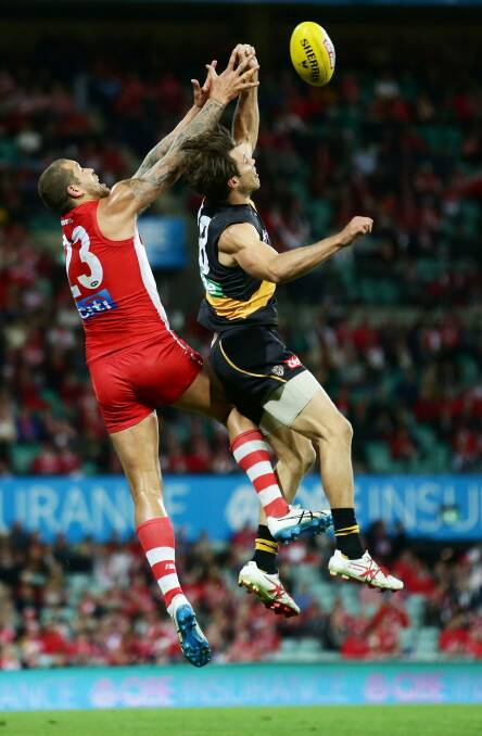 Alex Rance does battle with Lance Franklin of the Swans in the Tigers' final match for the year. Photo: Matt King