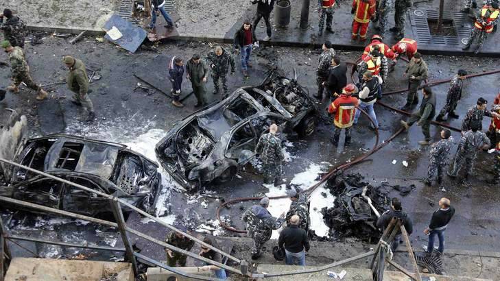 Civilians, soldiers and policemen gather at the site of an explosion in downtown Beirut on December 27. Former Lebanese Minister Mohamad Chatah and four others  were killed in the car bomb blast. Photo: Reuters