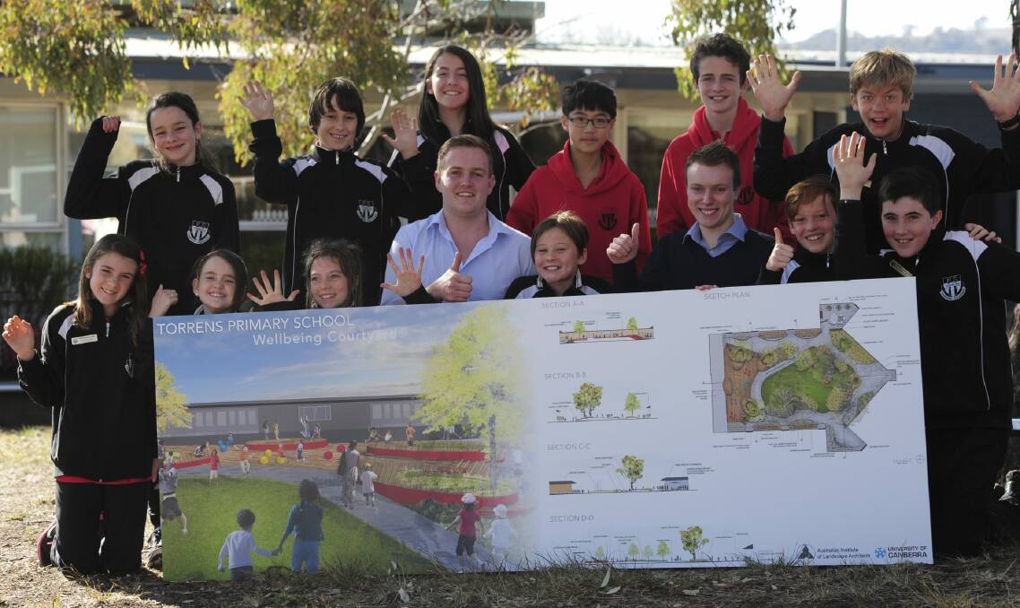 University of Canberra students Luke Duggan (centre front) and Chris Norris (third from right) with Torrens Primary School students at the launch of a new playground design. Photo: Graham Tidy