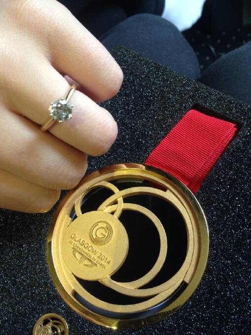 Boxer Andrew Moloney shows off his gold medal and his fiancee Chelsea-Madeleine Kean her diamond engagement ring.