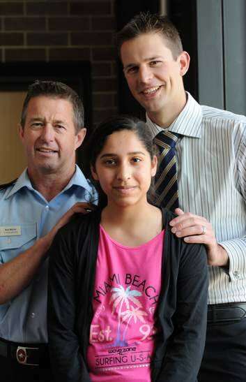 Zartash Sarwar, with her rescuers: ACT Fire and Rescue Station Officer, Neil Maher, left and Constable Paul Reynolds. Photo: Graham Tidy