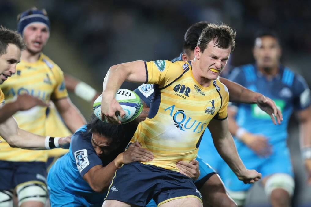 James Dargaville of the Brumbies is wrapped up by the Blues defence. Photo: Getty